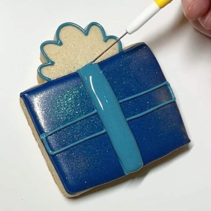 Step-by-step decorating instructions for how to decorate present cookies with royal icing