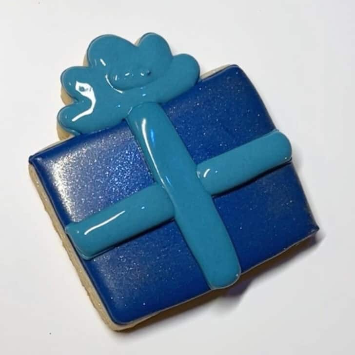 Step-by-step decorating instructions for how to decorate present cookies with royal icing