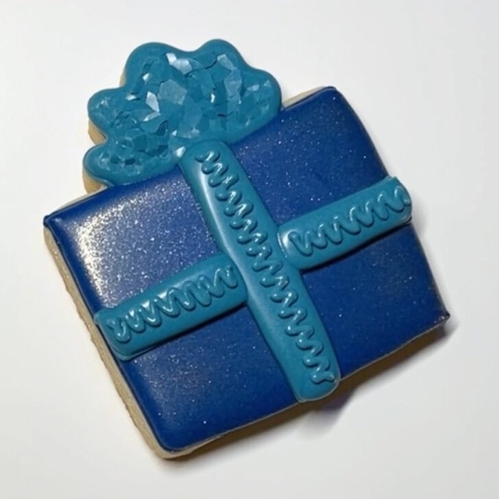 Step-by-step decorating instructions for how to decorate present cookies with royal icing