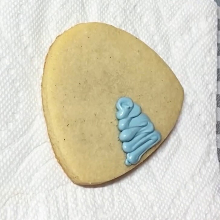 Step-by-step decorating instructions for how to decorate igloo cookies with royal icing