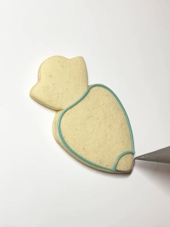 Step-by-step decorating instructions for how to decorate piping bag cookies with royal icing