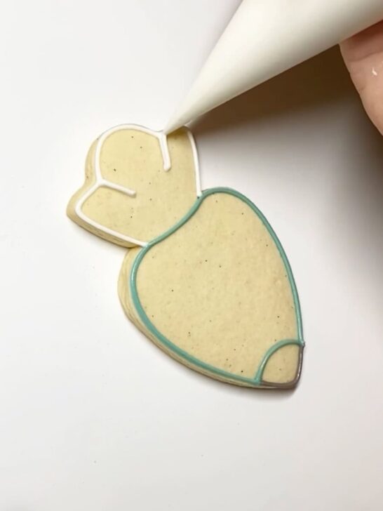 Step-by-step decorating instructions for how to decorate piping bag cookies with royal icing