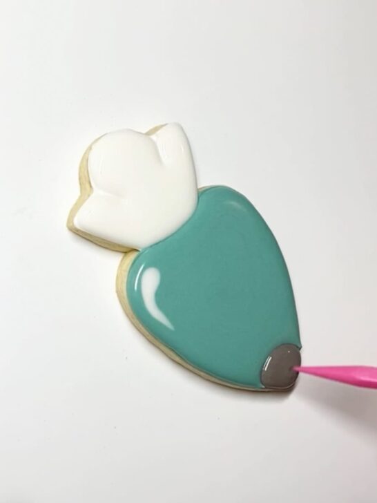 Step-by-step decorating instructions for how to decorate piping bag cookies with royal icing
