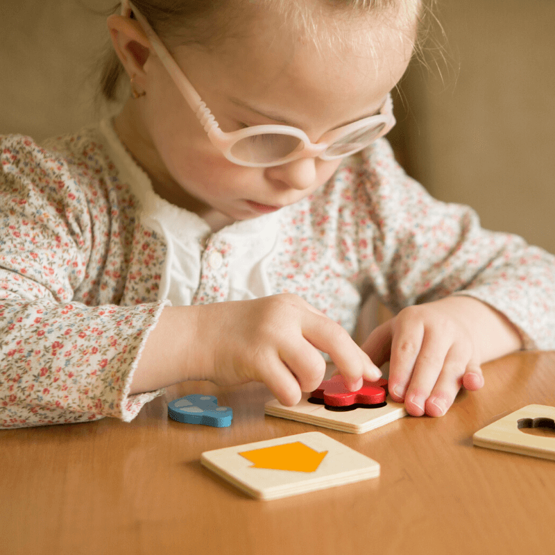 child playing with therapy toys