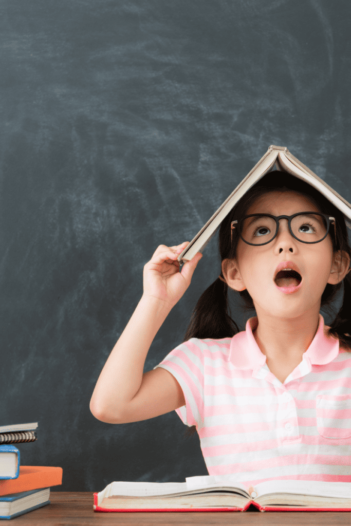 How to Prepare for Back To School. Child in a classroom with a book.
