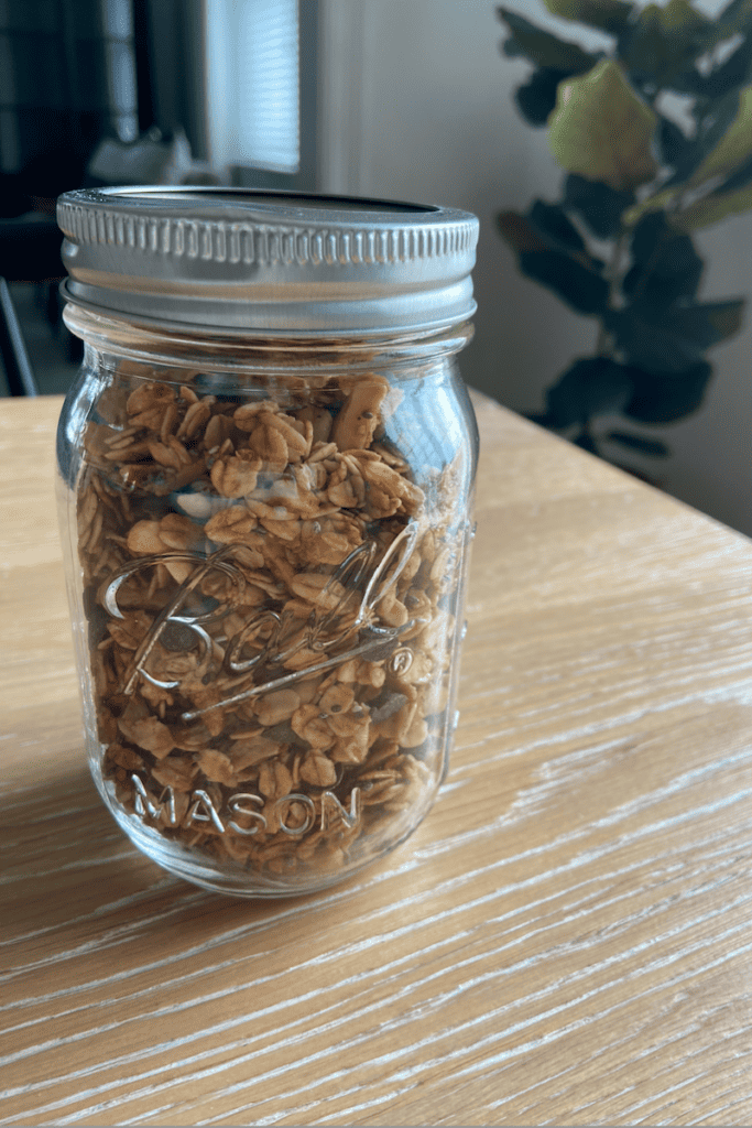 The Best Homemade Granola. Mason jar full of granola, on kitchen table.