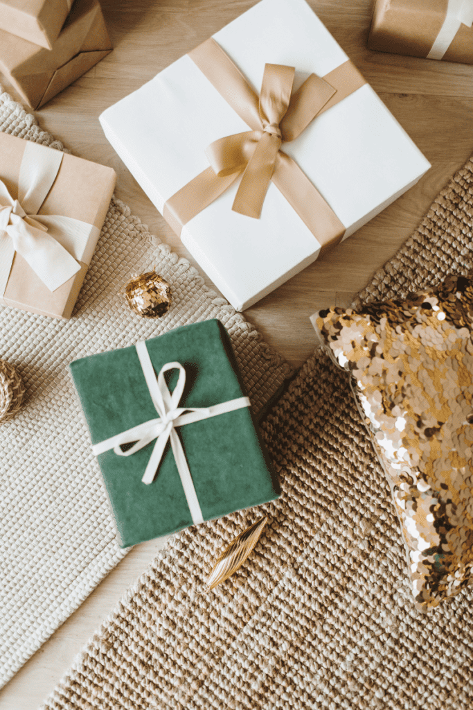 The Best Gifts for Her. Wrapped presents scattered on a neutral rug.