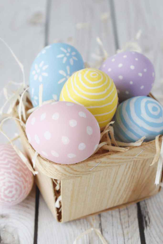 My Favorite Easter Basket Stuffers for Kids. Basket with colored eggs.