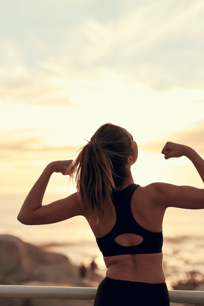 Five Things You Can Start Doing Today for Your Health. Woman outside flexing her muscles.