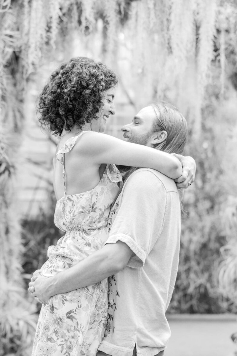 Candid moment during Daniel Stowe Conservancy engagement session with Maria and Eric