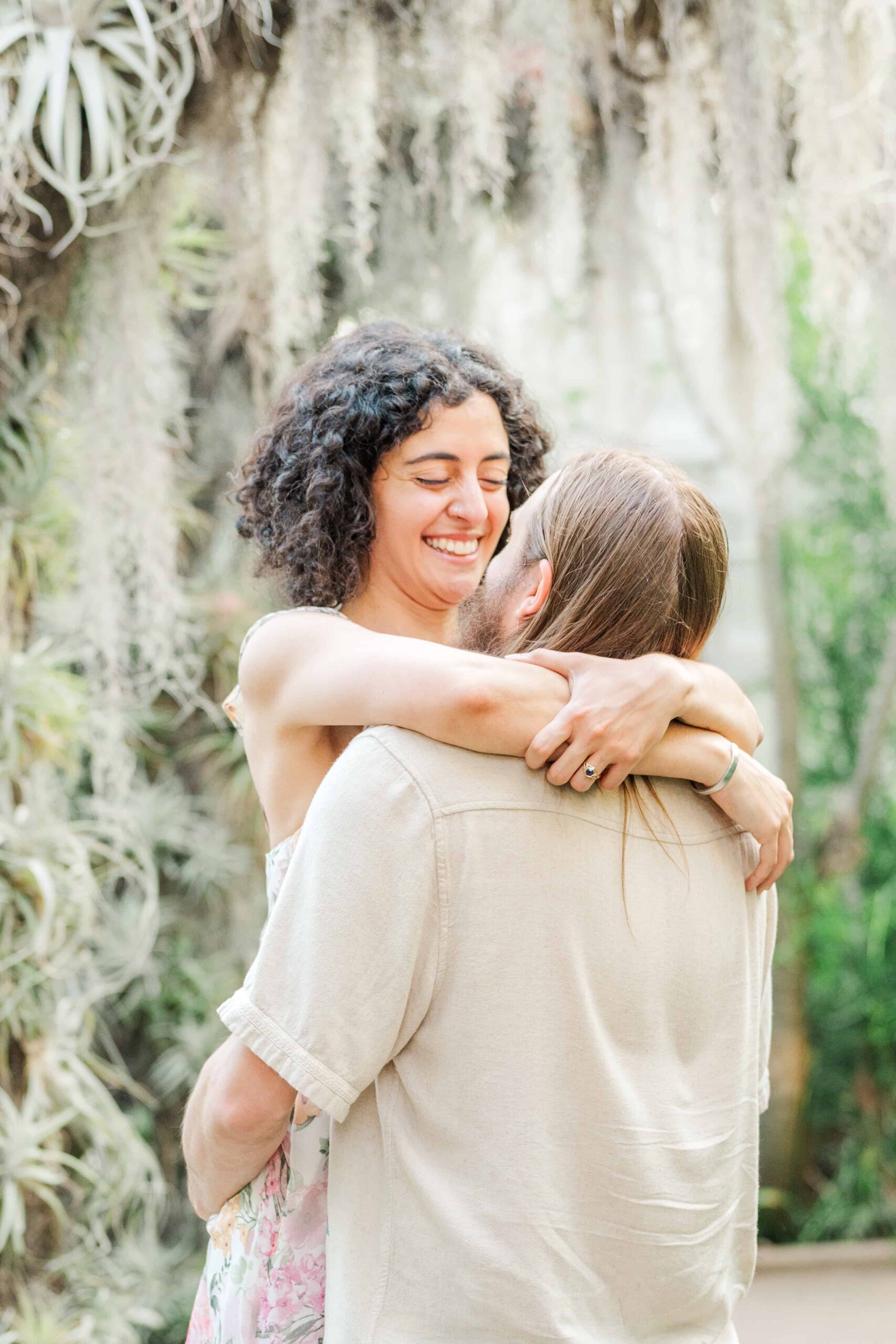 Close-up of engaged couple under tropical plants in the William H. Williamson, III Conservatory