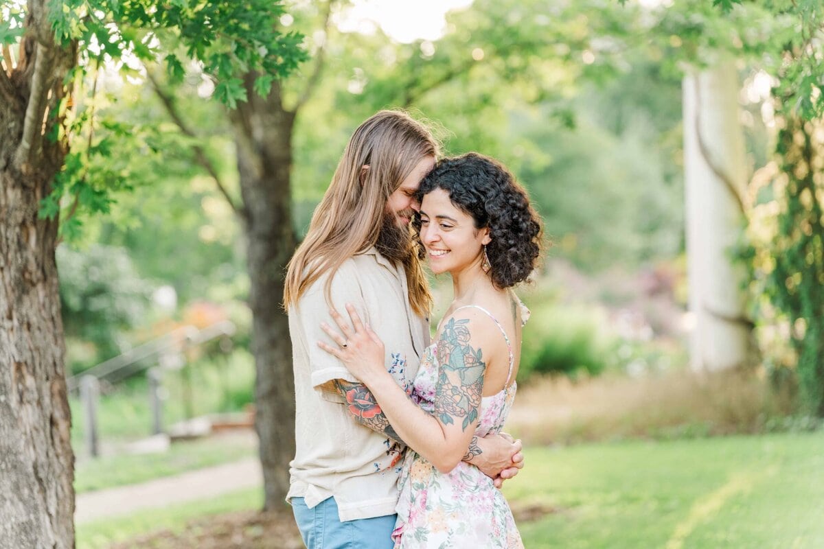 Natural posing during an engagement session at Charlotte-area conservancy gardens