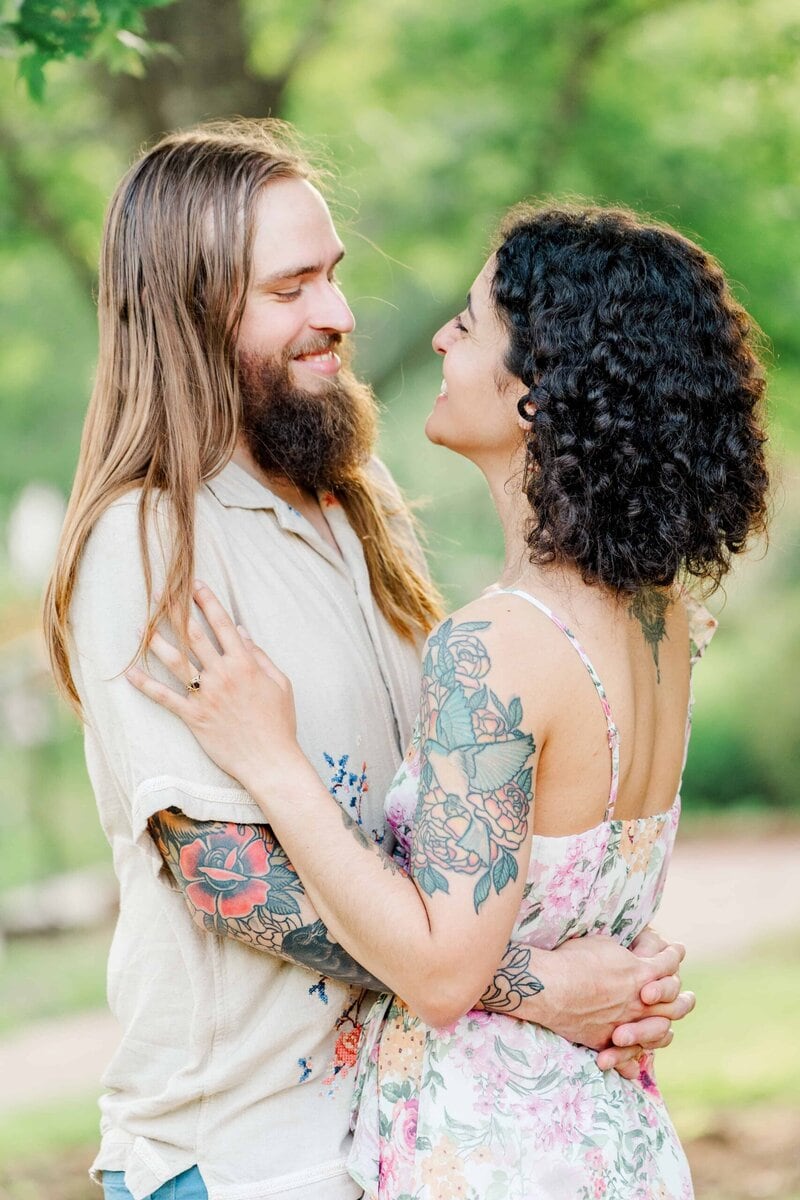 Laughter and connection during a candid couple moment at Daniel Stowe Conservancy