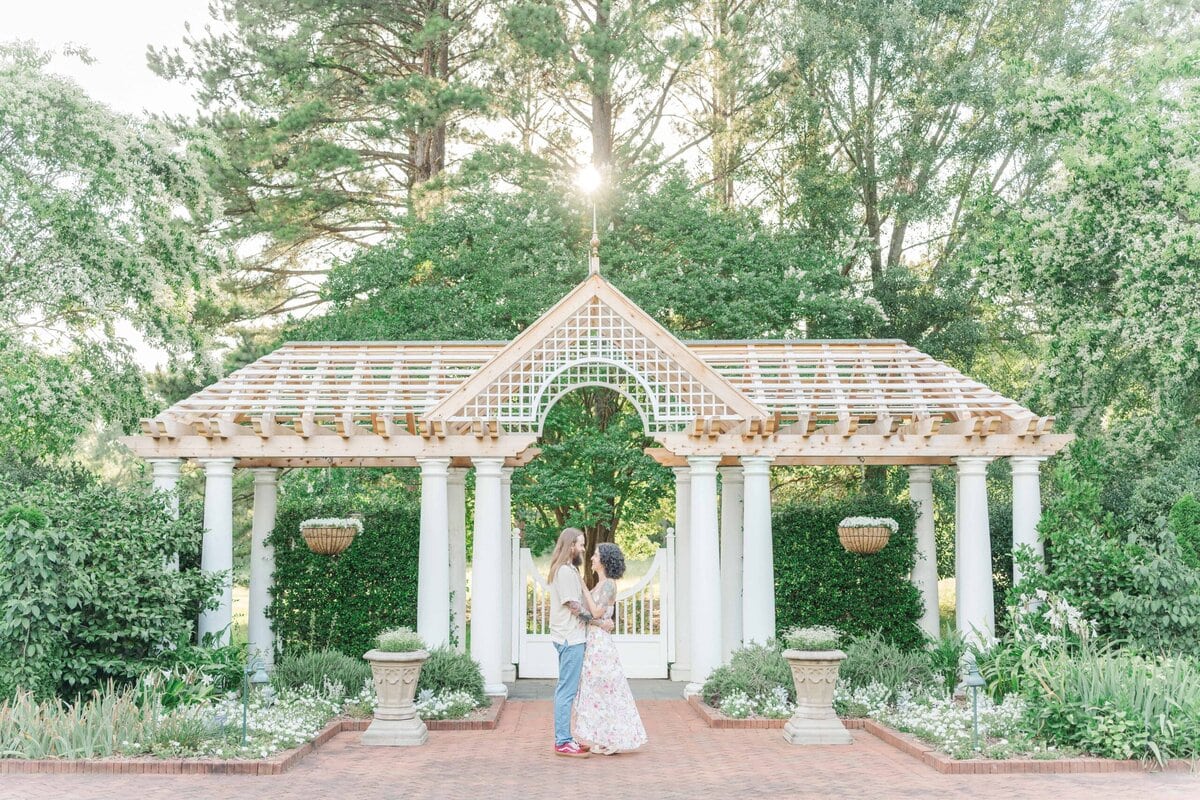 Outdoor engagement session in Belmont NC with natural light and lush gardens
