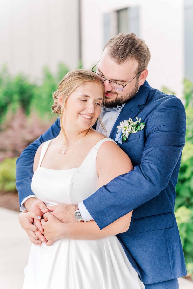 bride and groom posing at the fields at skycrest. Prioritize photography in your wedding budget to find a photographer who knows how to find light like this