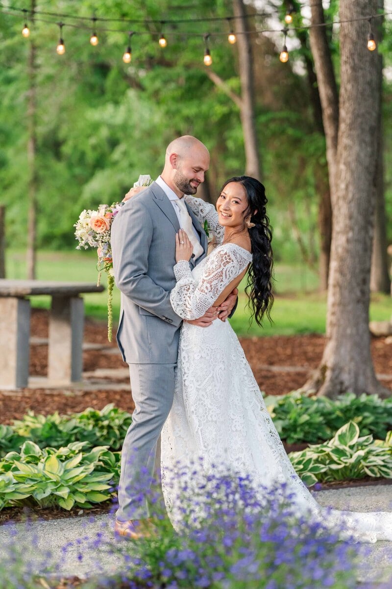 Bride and groom posing in the garden of low meadows estate