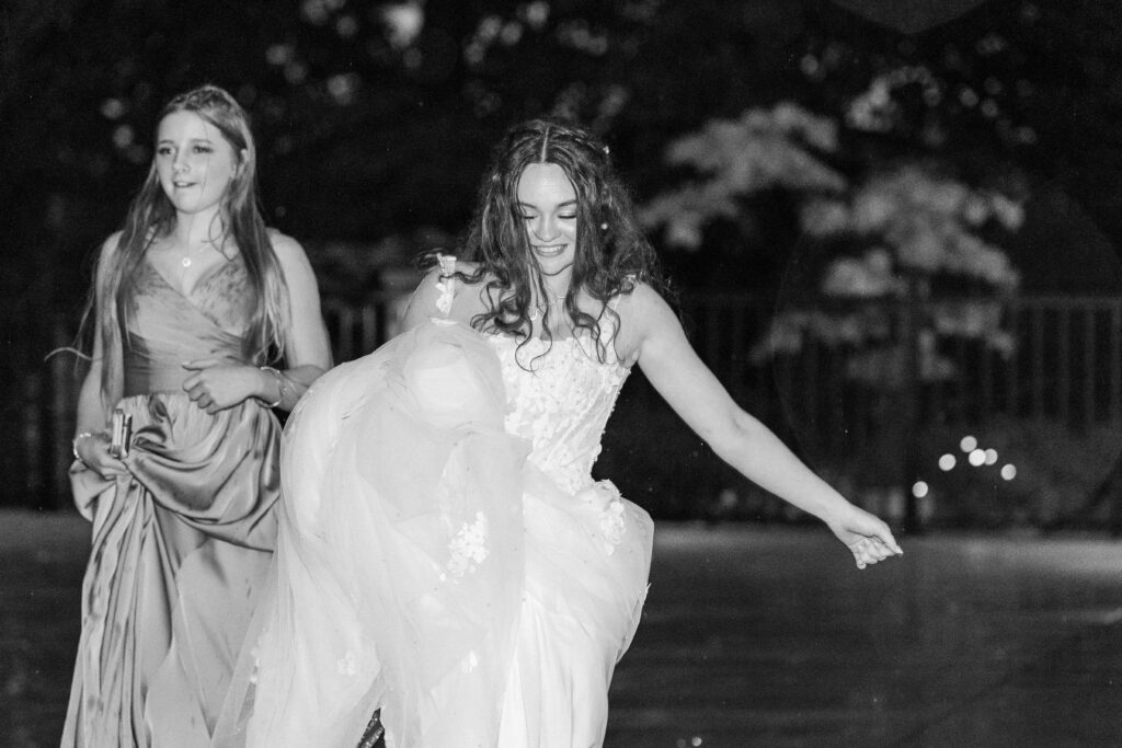 bride dancing barefoot in the rain at Heron Hill Venue wedding