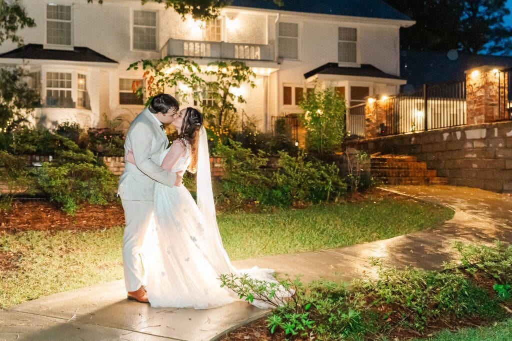 Bride and groom sharing a kiss outside Heron Hill Venue in South Carolina