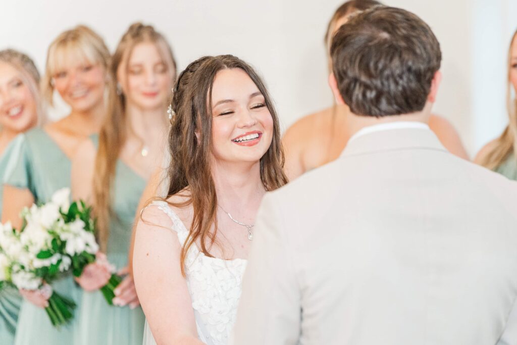 Couple smiling at each other during rainy wedding ceremony