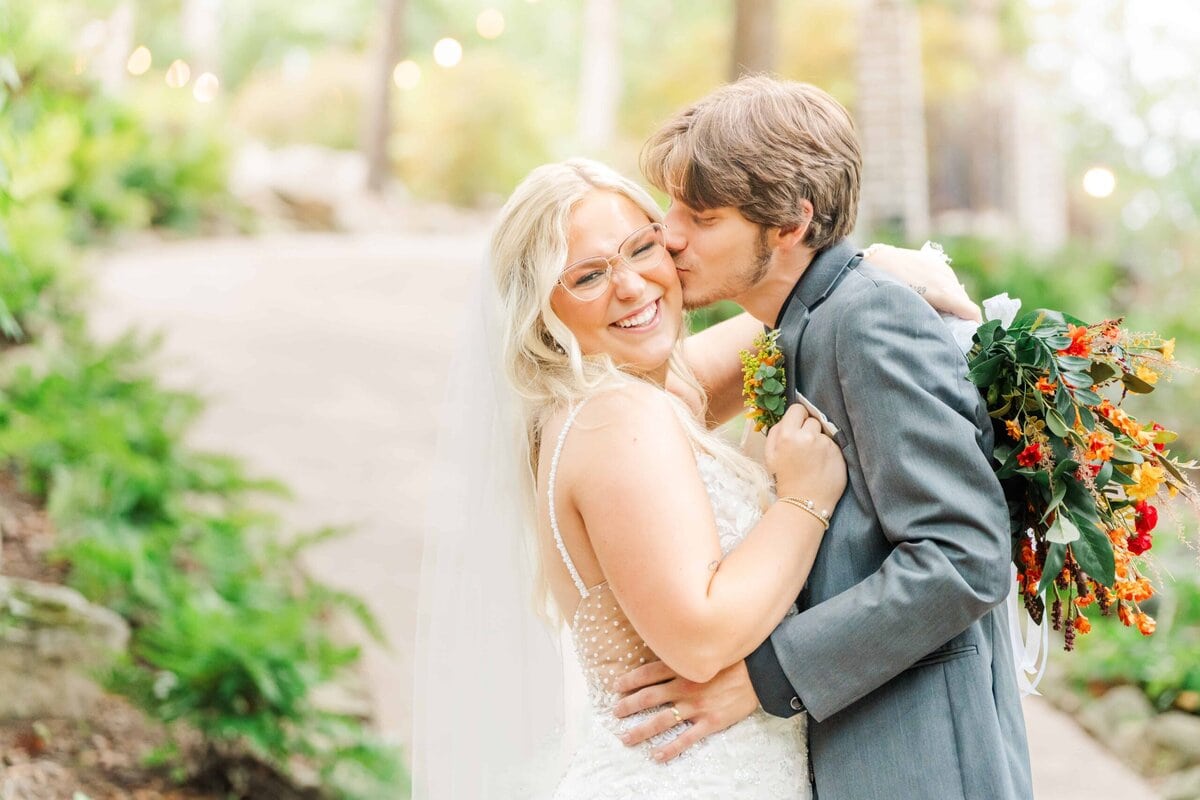 Bride and groom smiling under twinkle lights at Catawba Falls Events