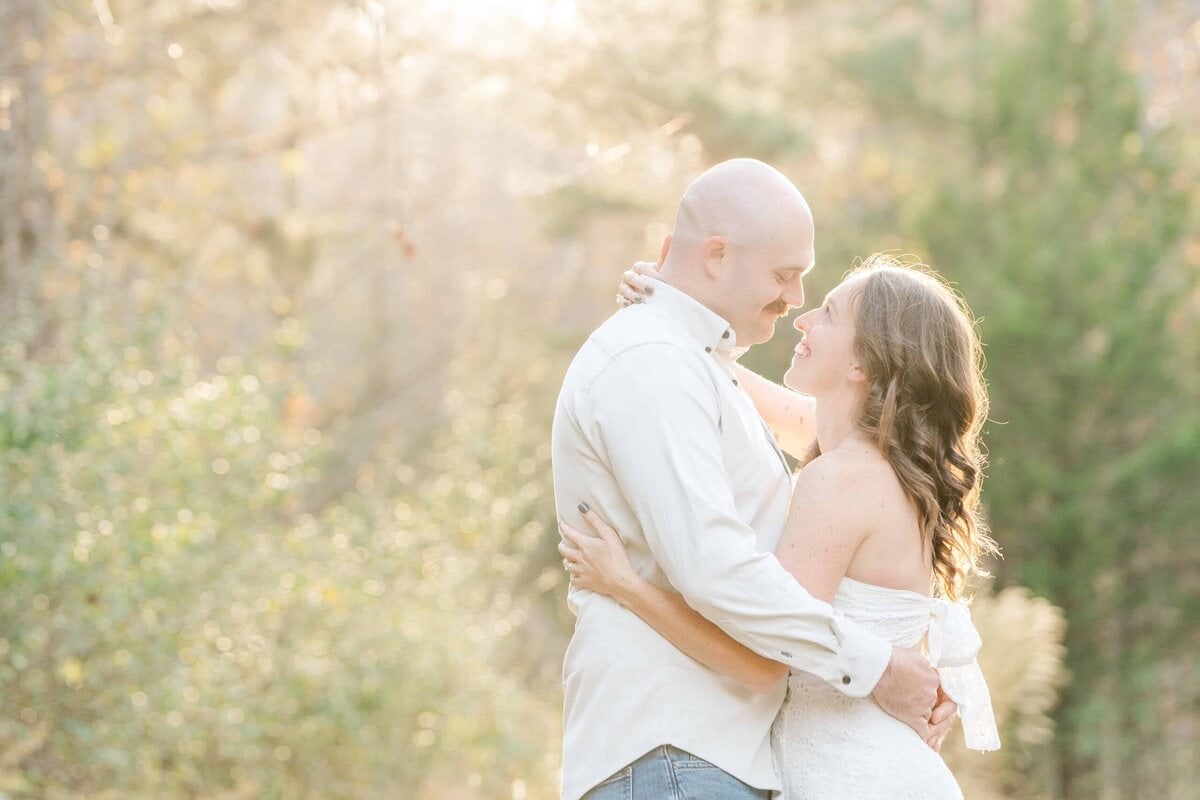 Outdoor engagement photos Charlotte featuring couple in soft golden light