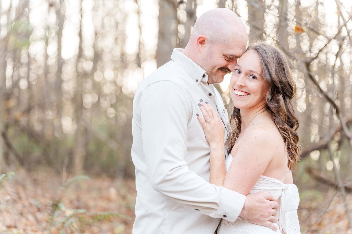 Close up of engaged couple smiling during sunset photo session in Charlotte