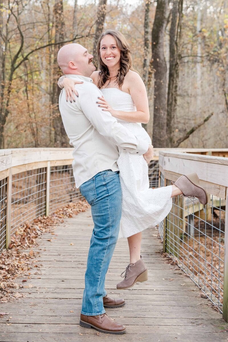 Beautiful engagement photos of couple on wooden bridge at Stevens Creek