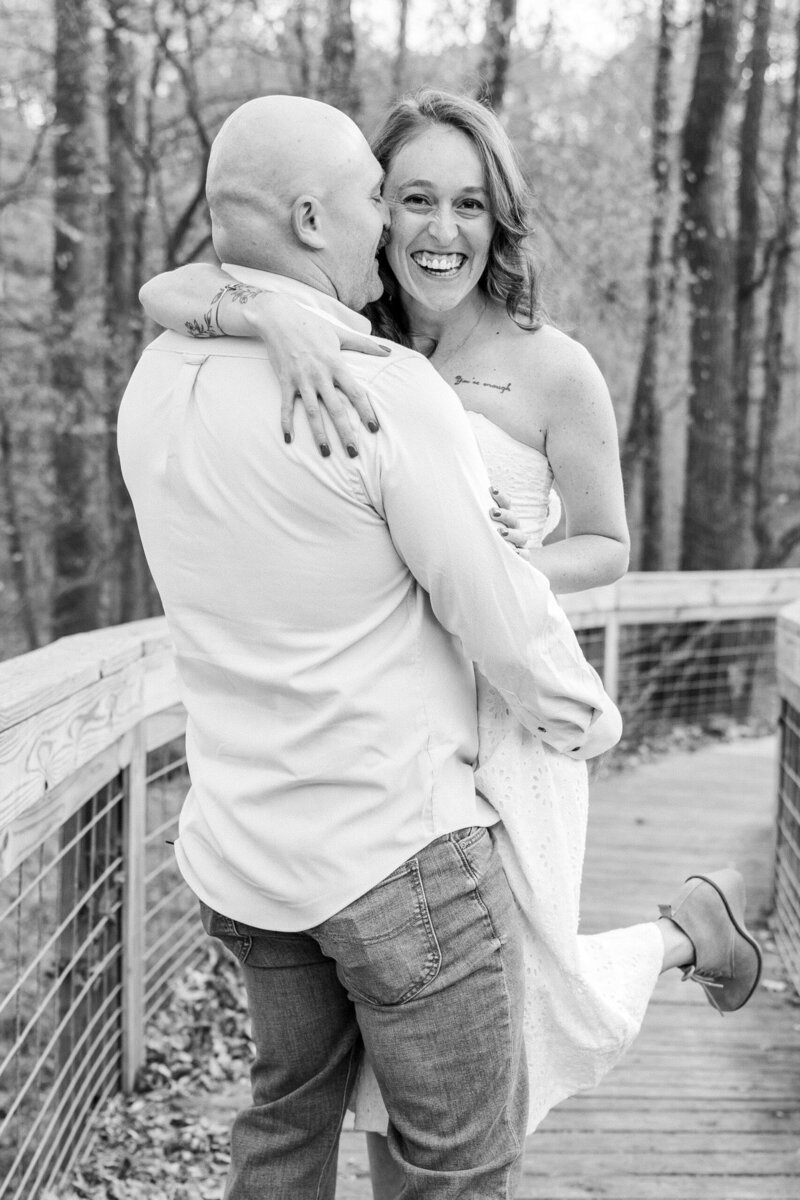 Corey and Tyler laughing together during nature filled engagement session