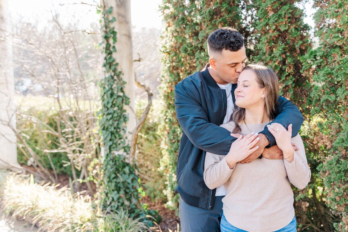 Winter engagement photos with greenery in Charlotte NC
