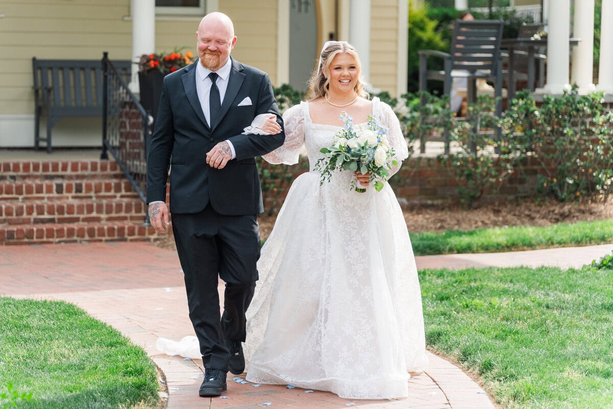 Bride walking down the aisle at the outdoor garden ceremony at Alexander Homestead, Charlotte NC wedding photographer