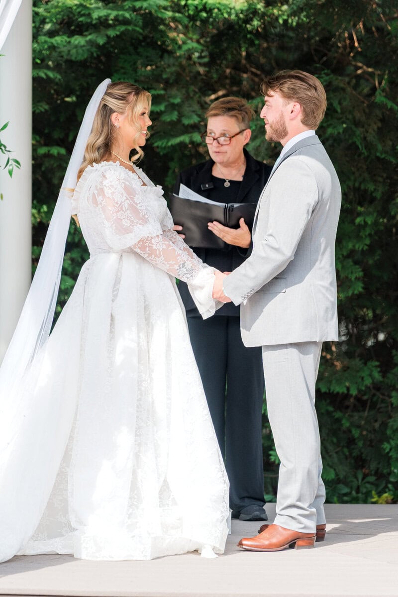 Officiant and couple at the white pavilion ceremony site at Alexander Homestead by Wedgewood Weddings, Charlotte NC