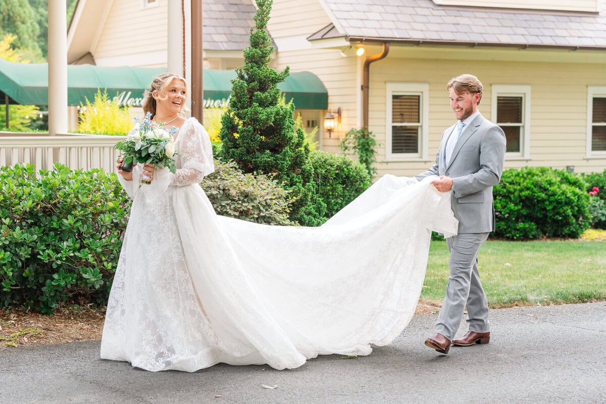 Bride Samantha with full lace train spread across the lawn at Alexander Homestead by Wedgewood Weddings, Charlotte NC