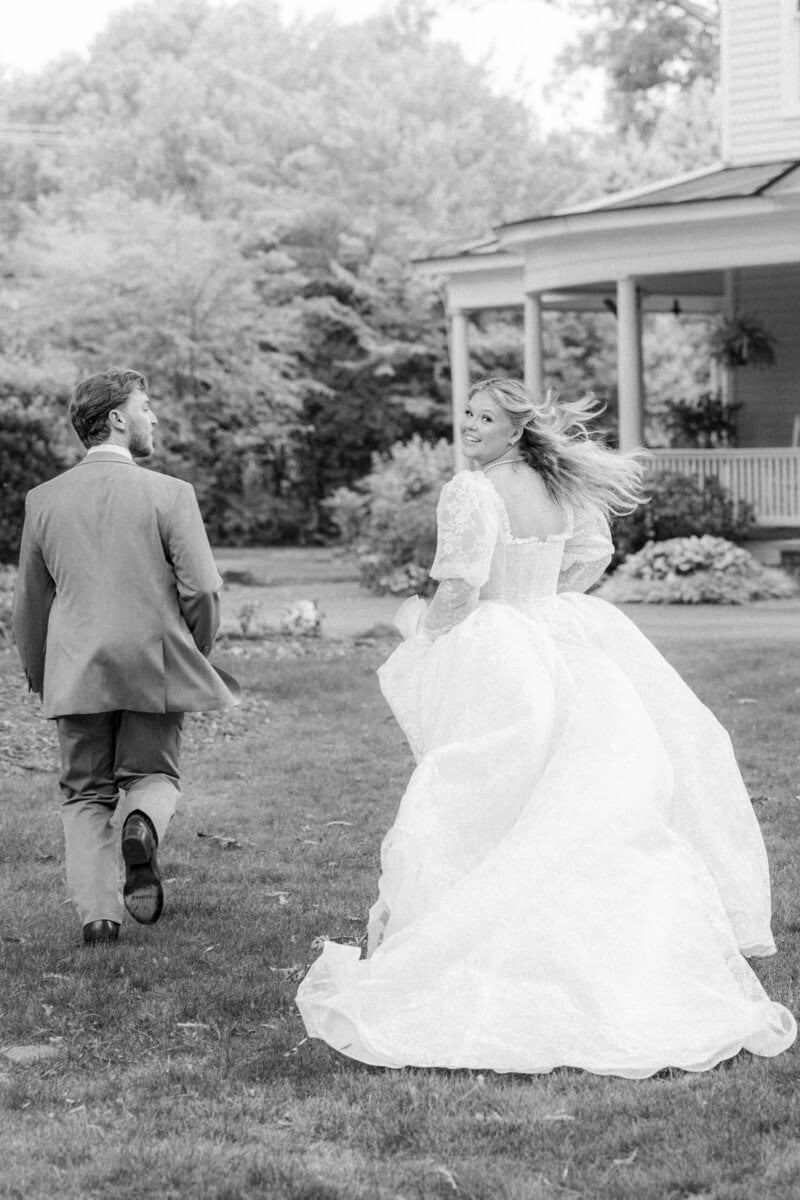 Bride and groom candid moment laughing during running portraits at Alexander Homestead, genuine emotion wedding photography Charlotte NC