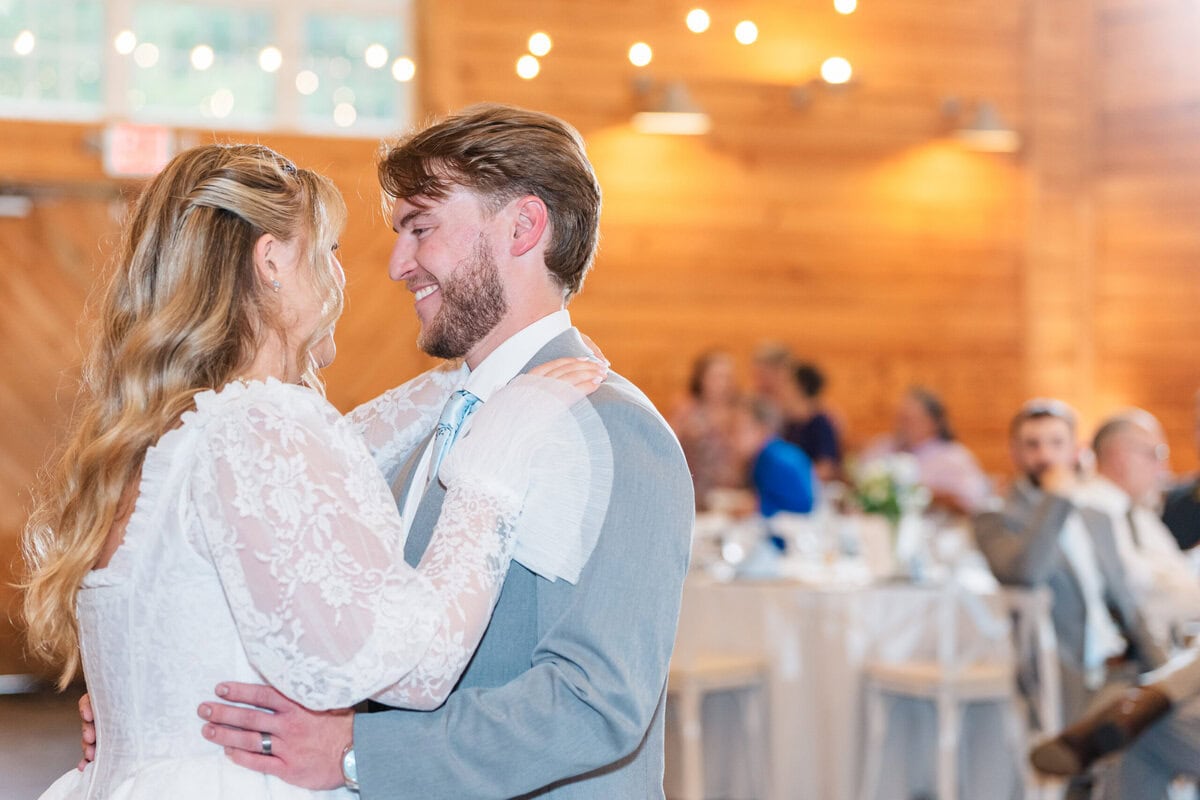 Bride twirling in long lace gown during first dance at Alexander Homestead Grand Hall, romantic wedding photos Charlotte NC