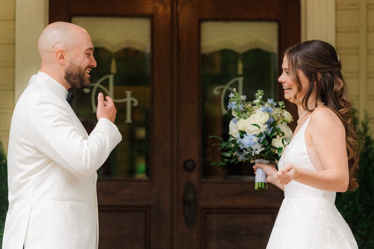 Bride and groom first look in the blooming rose garden at Alexander Homestead spring wedding