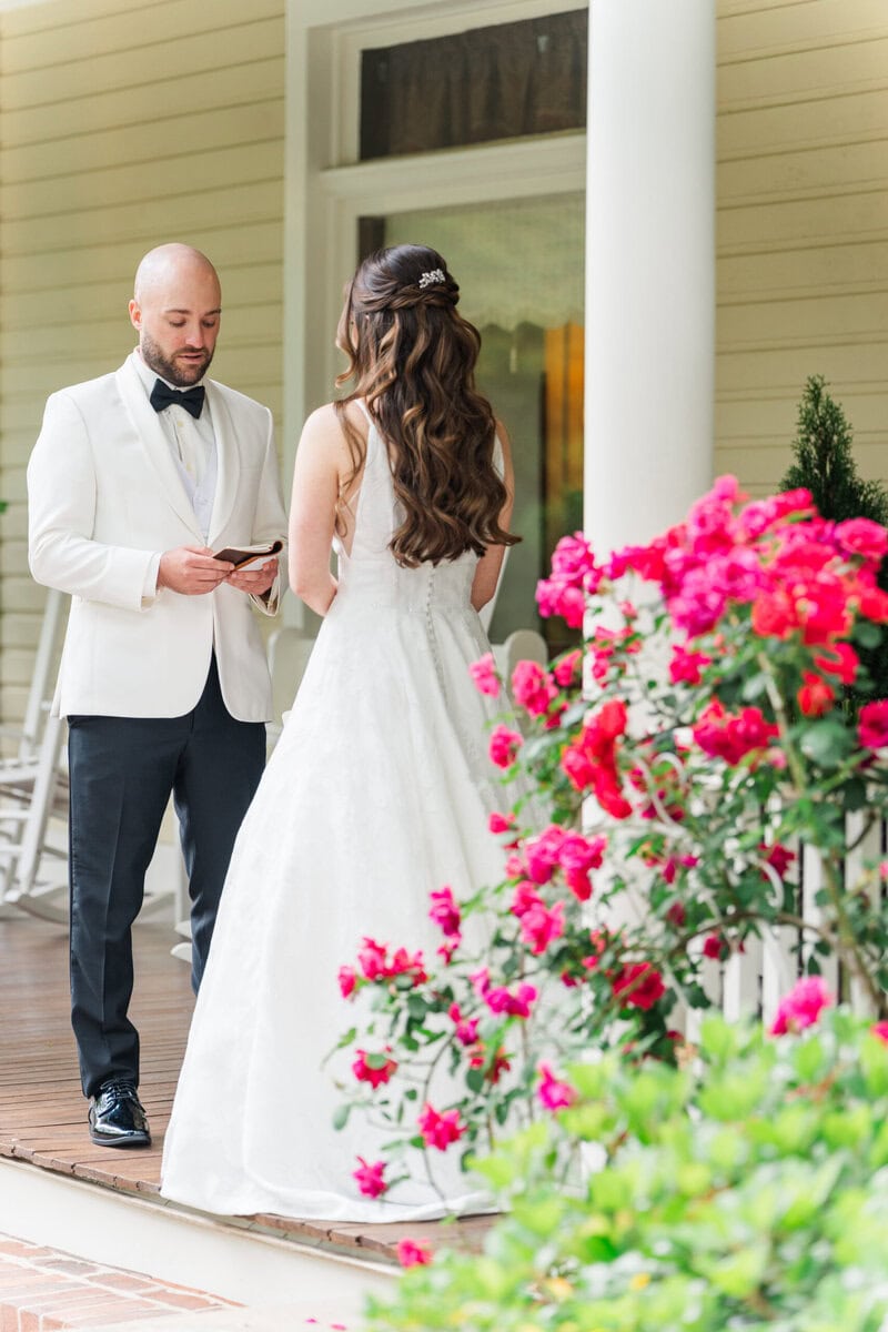 Groom in white suit with black pants and bow tie at Alexander Homestead wedding