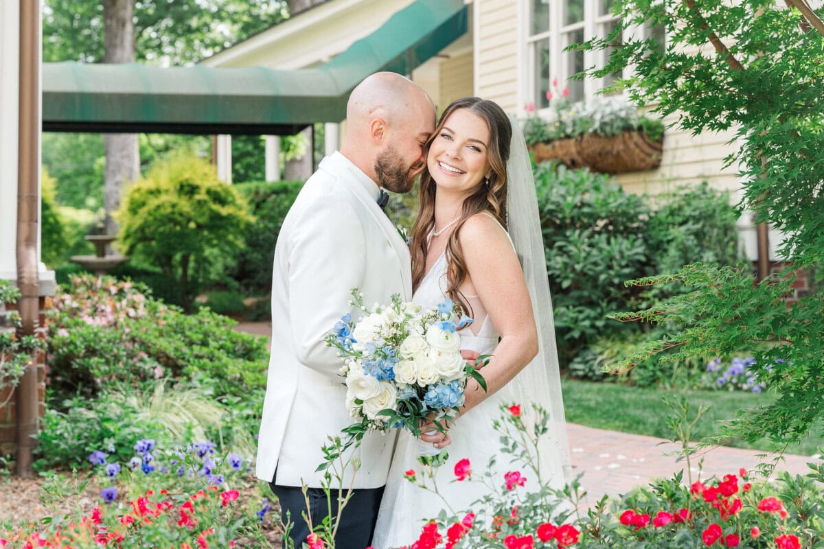 Bride and groom laughing together in the rose garden at Alexander Homestead Charlotte NC