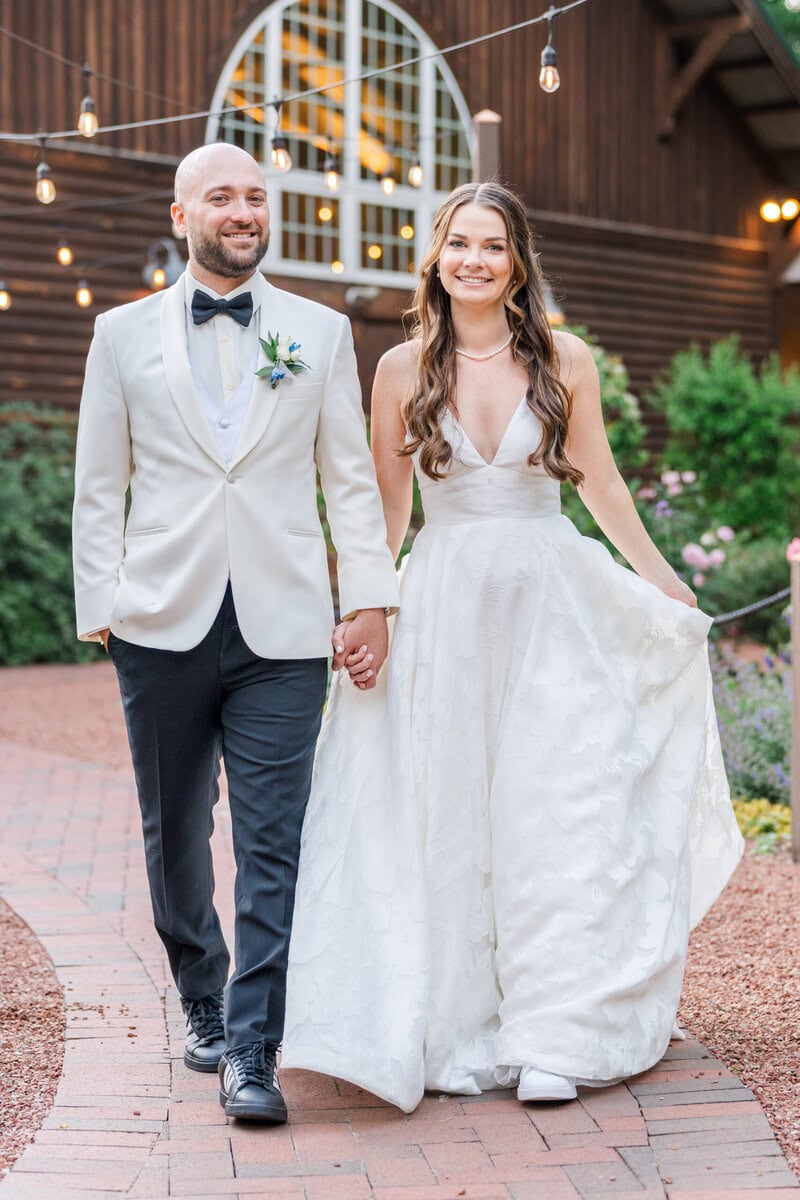Groom in white suit coat portrait in blooming spring garden at Alexander Homestead