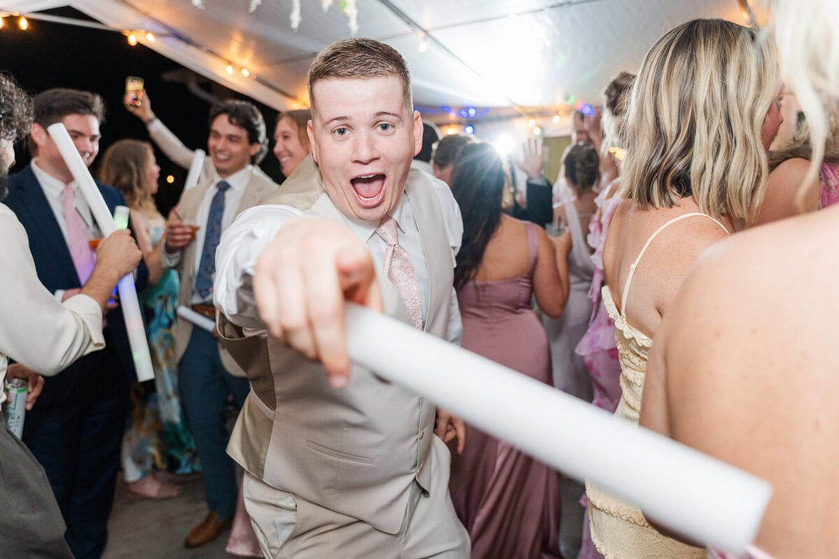 lively reception dancefloor under white tent rain Mariposa Chapel Iron Station NC
