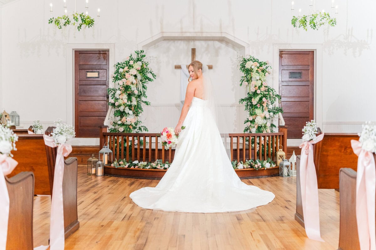 ceremony inside Mariposa Chapel white walls wooden floors spring wedding near Charlotte NC