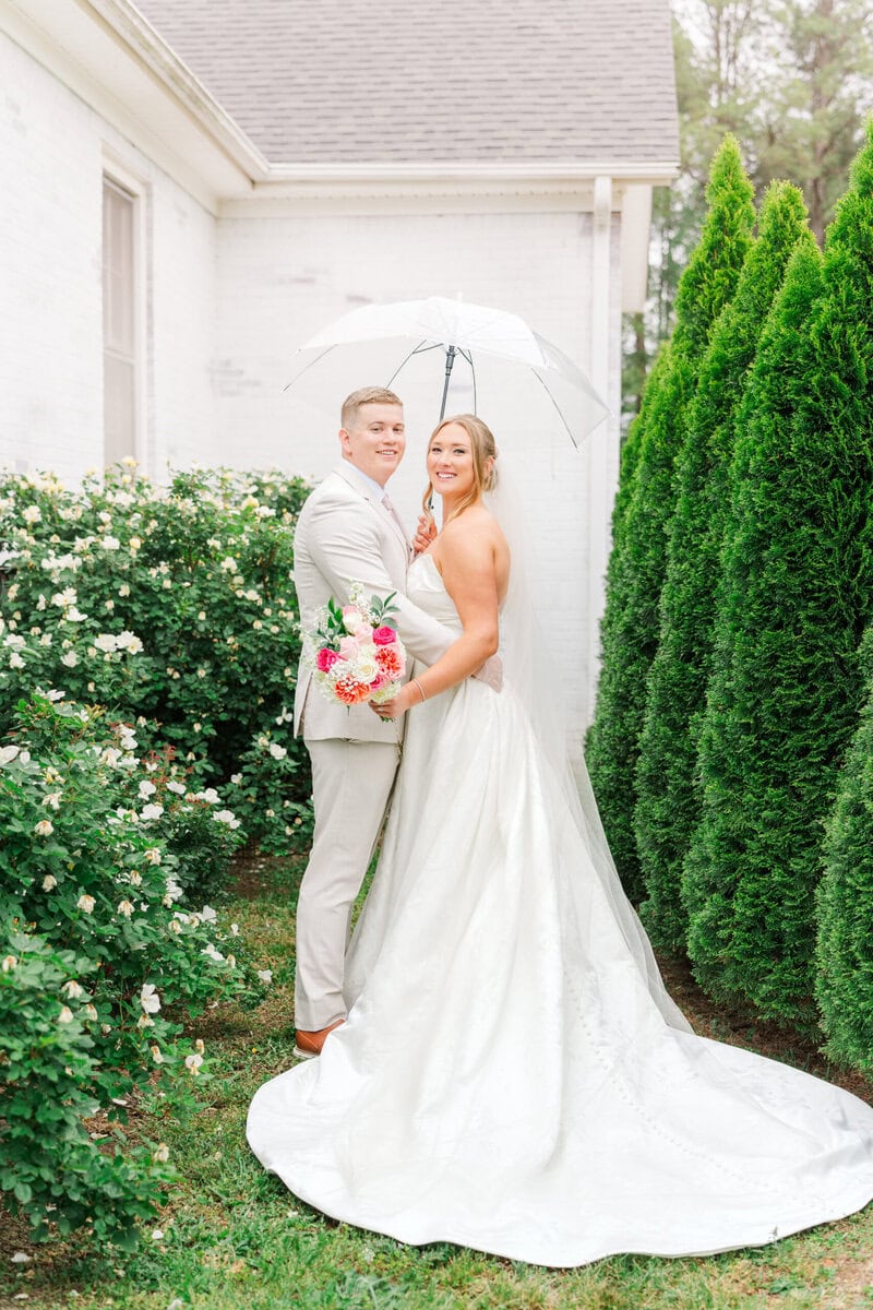 bride and groom just married portrait outside Mariposa Chapel white chapel rainy spring wedding