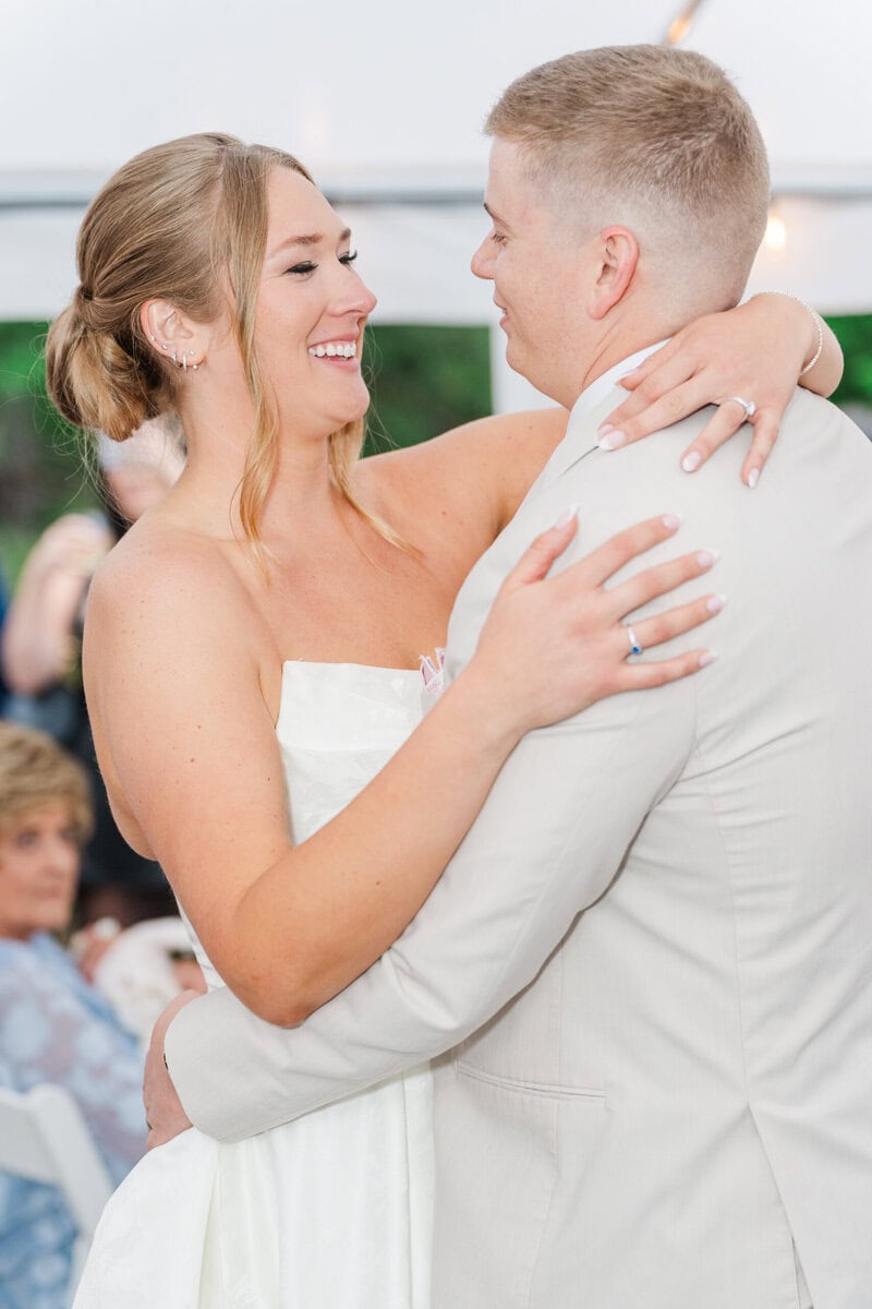 first dance under white tent Mariposa Chapel rainy wedding reception Iron Station NC