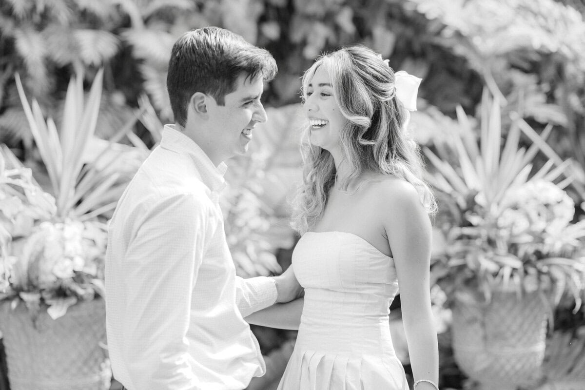 Romantic portrait of newly engaged couple inside Daniel Stowe Botanical Garden Orchid Conservatory during spring proposal session The Lilac Lion Photography Charlotte NC wedding photographer