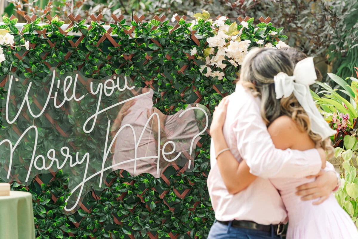 surprise proposal inside the Orchid Conservatory at Daniel Stowe Botanical Garden photographed by Charlotte proposal photographer The Lilac Lion Photography