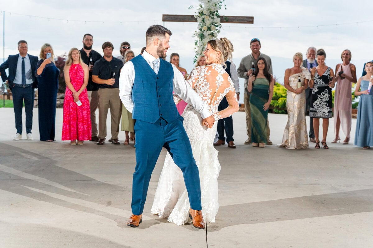 Wedding reception first dance under covered porch Hidden Hill Venue Morganton North Carolina