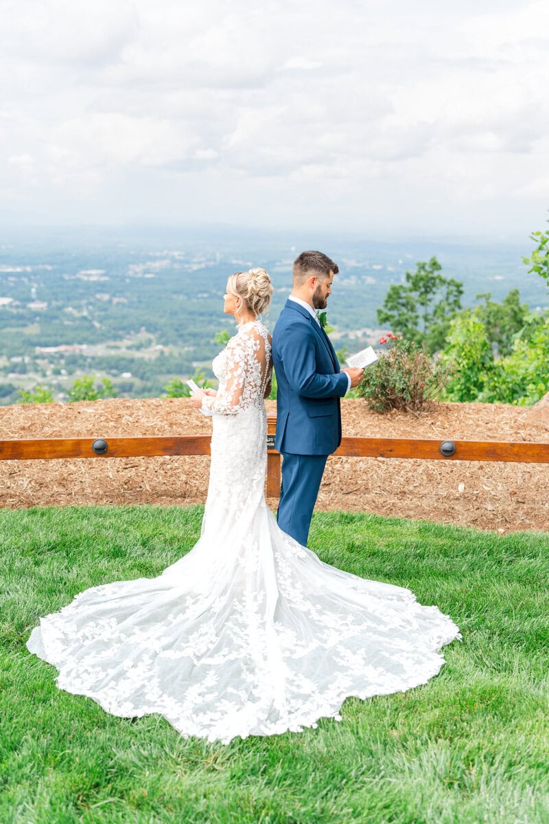 Lacy and Karson first touch outside at Hidden Hill Venue with Blue Ridge Mountain views behind them Morganton NC