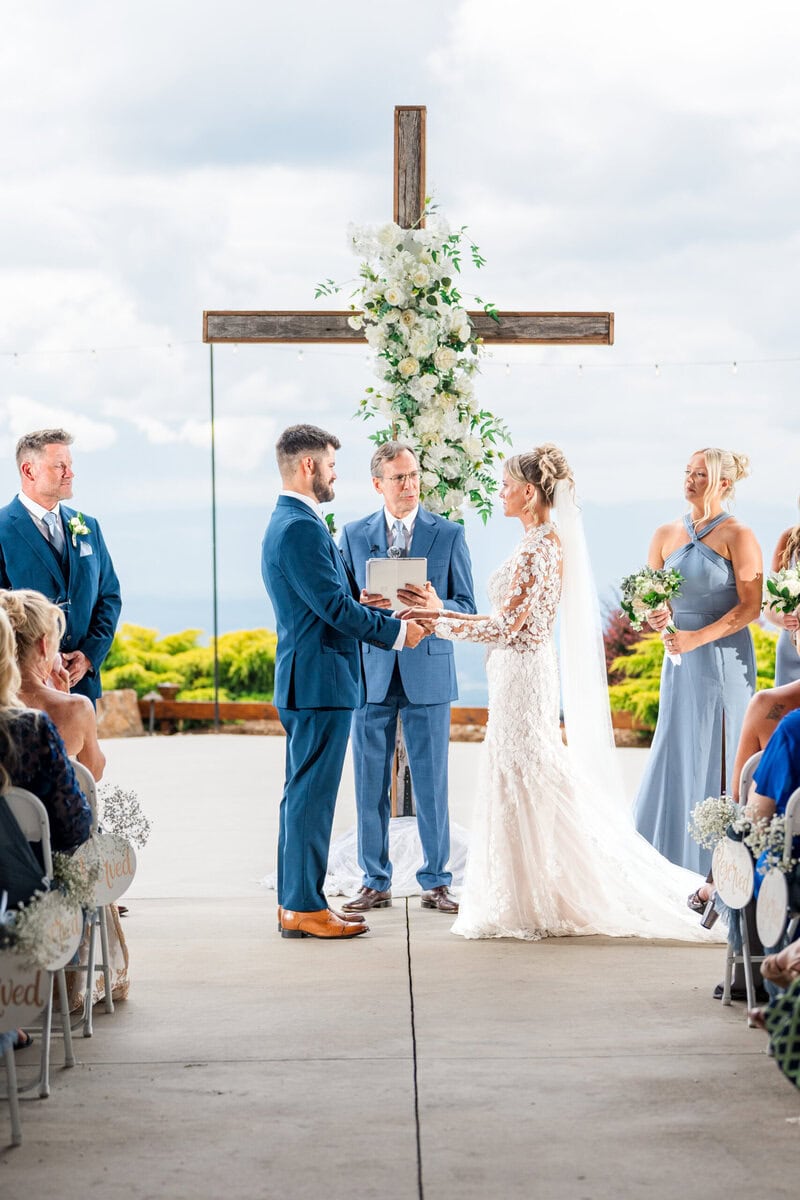 Wedding ceremony under covered porch at Hidden Hill Venue Morganton North Carolina with mountain backdrop