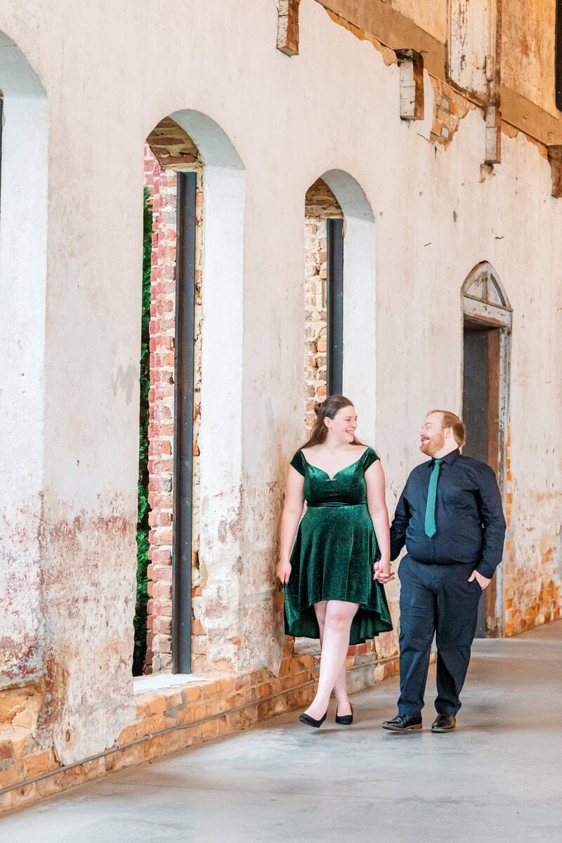Soft natural light portraits inside The Providence Cotton Mill with 30-foot ceilings and weathered plaster walls