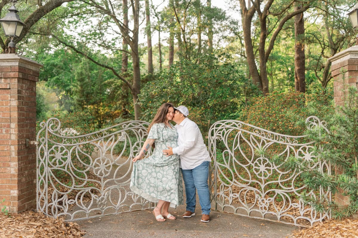 Ashley and Nikki walking through one of the park's decorative gates during their engagement shoot