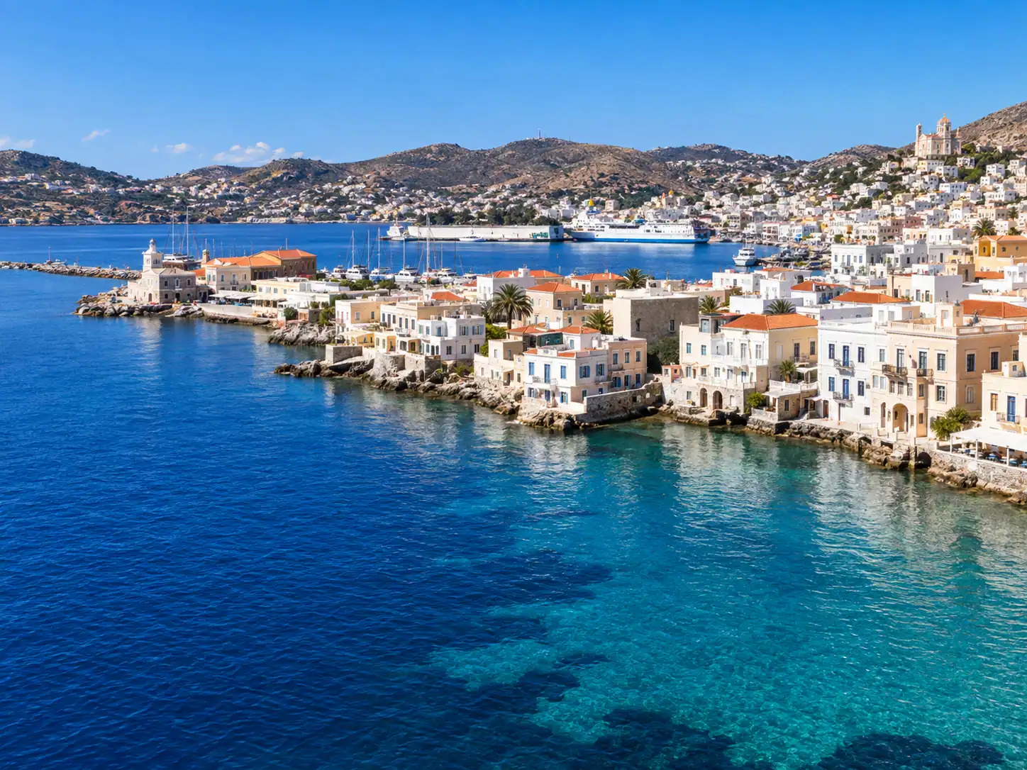 View across Ermoupoli on Syros with its harbor, neoclassical buildings and Aegean coastline